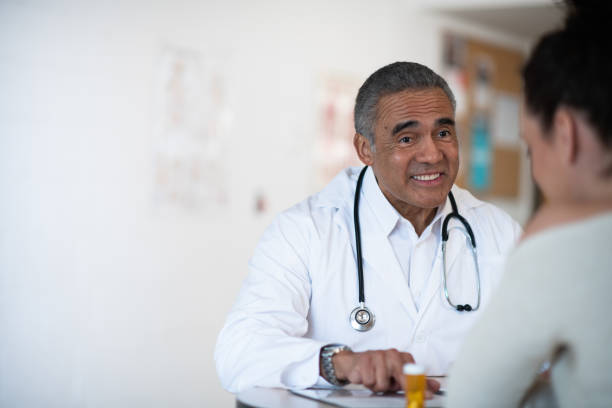istock Male doctor talking to his patient 1156350146