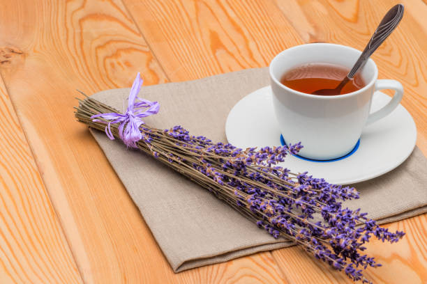 istock hot tea in a cup with lavender on a linen napkin close-up 1156350853