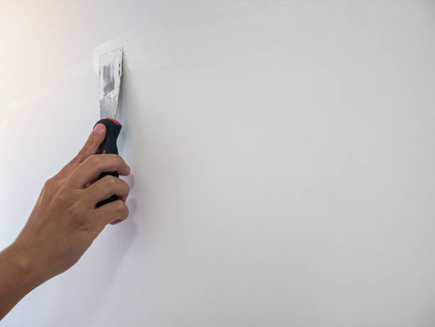istock Plasterer hand repair crack white wall 1156351081