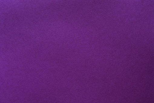 Purple felt texture abstract art background. Solid color wool textile. Empty space.