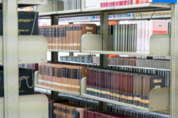 istock Blurred public library bookshelf in the library room. 1156355149