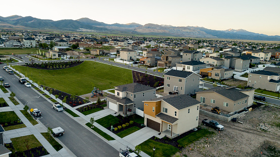 A sweeping drone view of newly constructed homes and existing neighborhoods in the Salt Lake City area