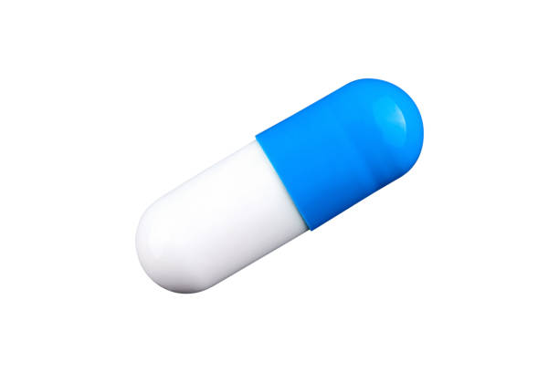 macro photo of blue and white capsule. isolated - medicine dose medical medicine and science imagens e fotografias de stock