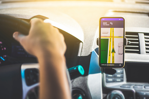 A person using a hands free phone clip whilst driving a car.