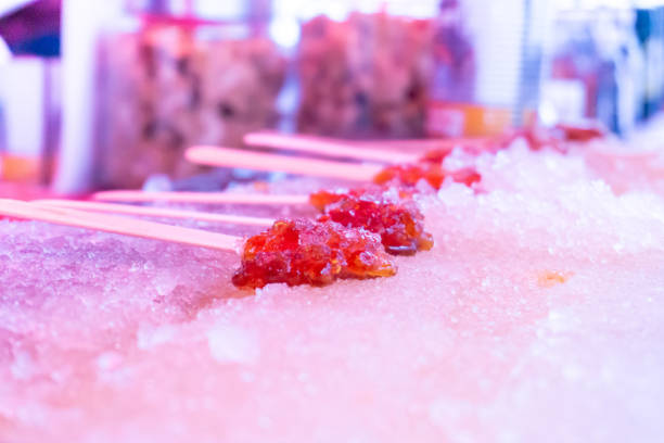 istock Maple snow candy sticks (maple toffee) sitting on ice, after being rolled by a maple syrup and sugar vendor. A classic Canadian treat. 1156362475