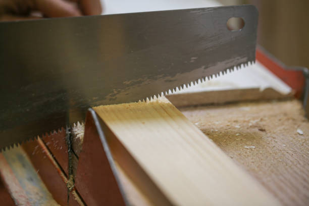 istock person sawing the wooden plank edge 1156367009
