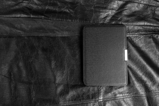 istock Electronic book in the case on black leather background 1156367026