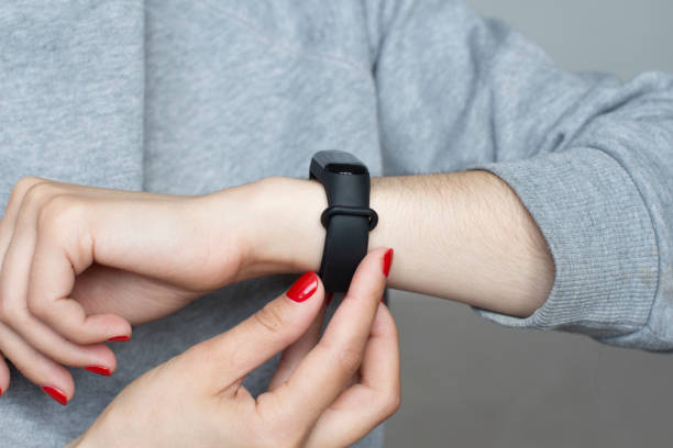 istock young woman using her smart watch 1156370529