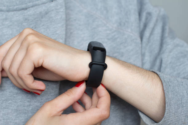 istock young woman using her smart watch 1156370543