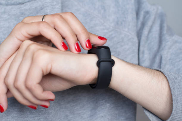 istock young woman using her smart watch 1156370555