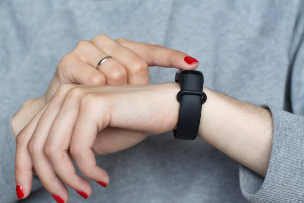 istock young woman using her smart watch 1156370578