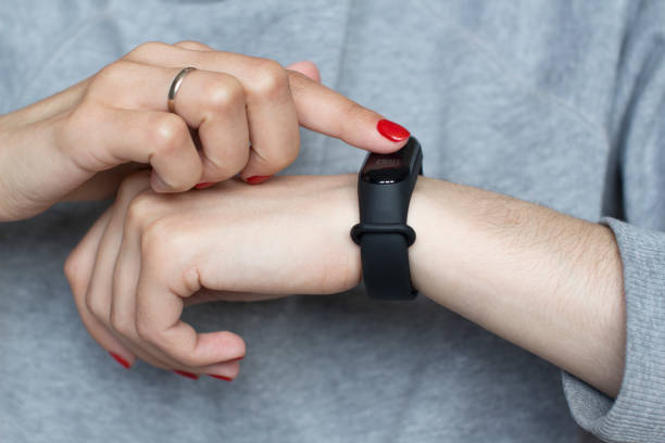 istock young woman using her smart watch 1156370579