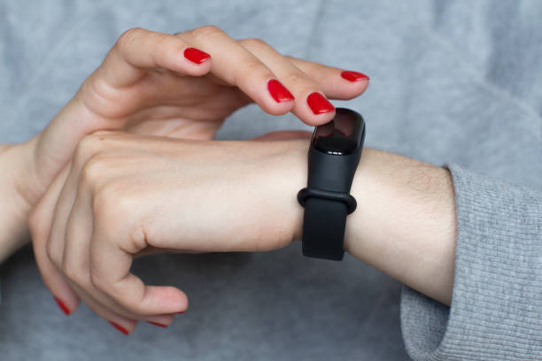 istock young woman using her smart watch 1156370580