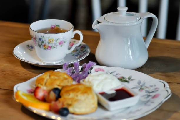 istock tea and scone with fruit ,whipping cream 1156373283