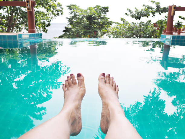 istock Woman selfie barefoot in swimming pool 1156374067