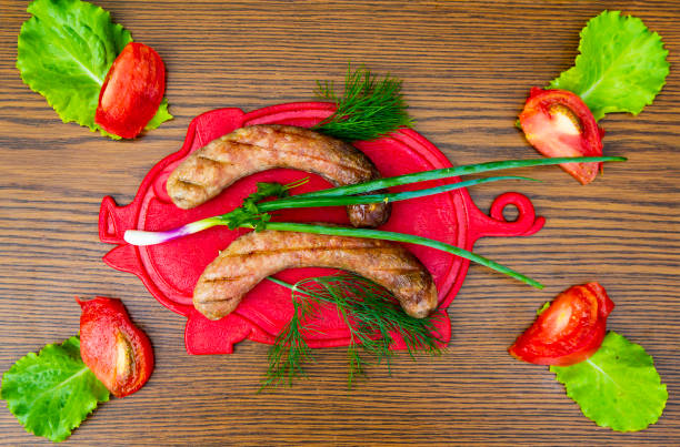 istock Bavarian sausages on a cutting board with vegetables. 1156378376