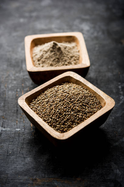 istock Bajra (pearl millet) / sorghum grains with it's flour or powder in a bowl, selective focus 1156378396