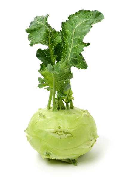 istock Fresh kohlrabi with green leaves on isolated white backround 1156379800