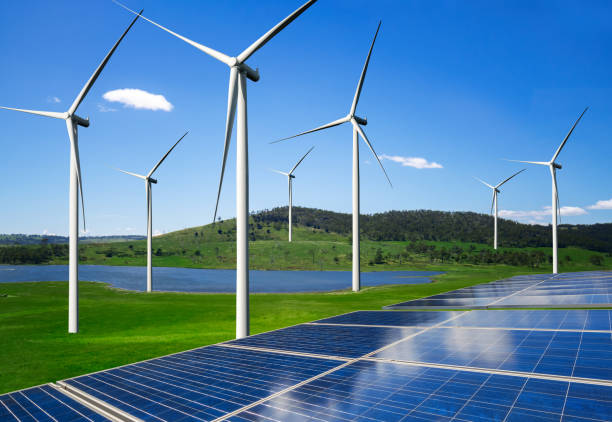 istock Solar panel and wind turbine farm clean energy. 1156386858