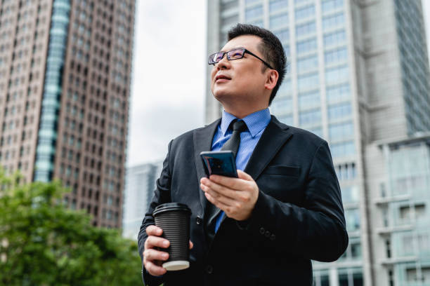 istock Taiwanese Business Executive Outdoors With Smart Phone 1156392868