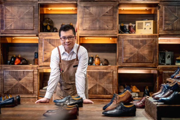 istock Confident Male Taiwanese Shoe Store Owner 1156393564