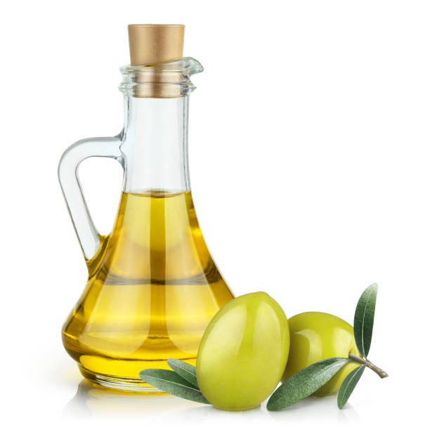 istock Olive oil and olives on white 1156394624