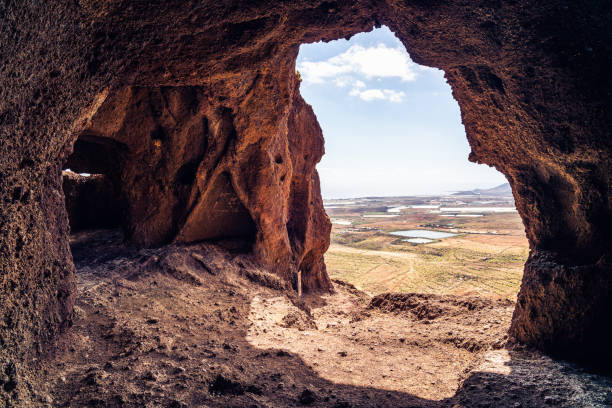 istock Cuatro Puertas, aka four doors caves or Cueva de los Papeles, archaeological site in Gran Canaria, Spain. View from the inside of the cave. 1156395098