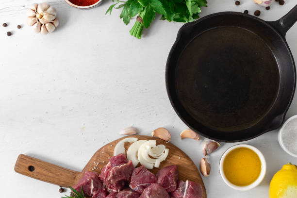 istock Cooking meat with vegetable white wooden background top view 1156395731