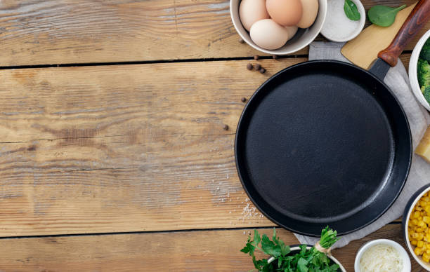 istock Healthy breakfast table with empty cooking pan and ingredient cooking on wooden background top view copy space. Broccoli, eggs, spinach and cheese on table 1156395847