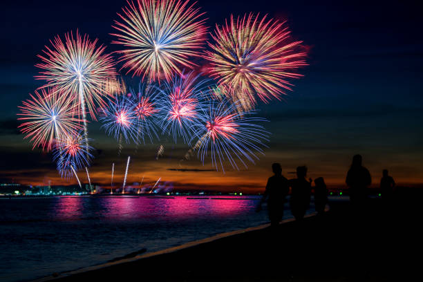 istock Silhouette people looking beautiful fireworks display on the beach ,celebration new year night concept 1156396050