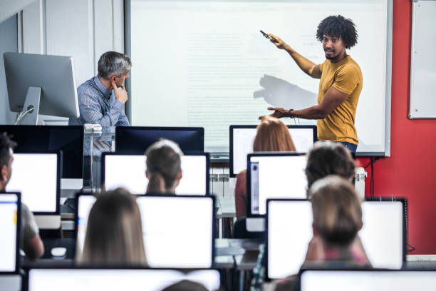 istock African American student presenting his classmates a lecture at computer class. 1156396274