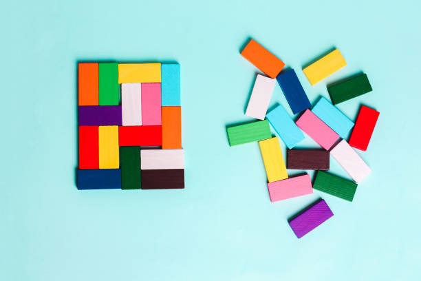 order and chaos. Chaotic unorganized colored dominoes and ordered. order and chaos. Chaotic unorganized colored dominoes and ordered. Concept of business model, organization. Left and right hemisphere of the brain. chaos stock pictures, royalty-free photos & images