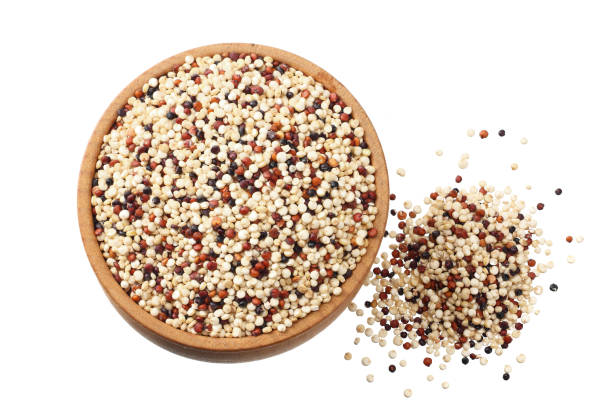 istock quinoa in a wooden bowl isolated on white background. quinoa seed. top view 1156399480