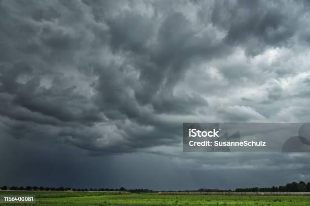 Threatening Storm Clouds Over Farmland Stock Photo - Download Image Now - Storm Cloud, Rain, Sky