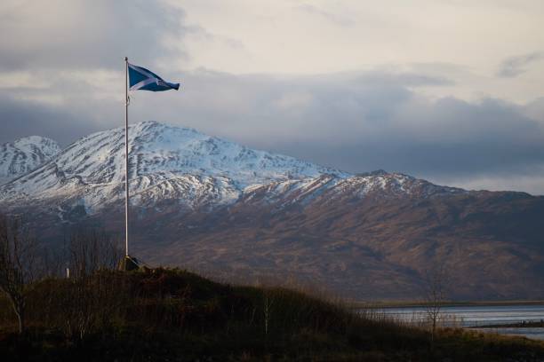 istock Scottish flag waving in front of mountain scenery 1156405556