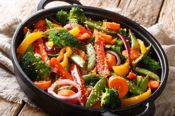 istock Quick-fried vegetables with sesame in Asian style close-up in a bowl, horizontal 1156405823