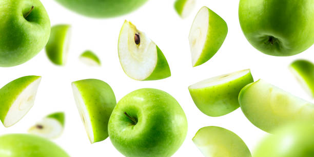 istock A group of green apples levitating on a white background 1156405881