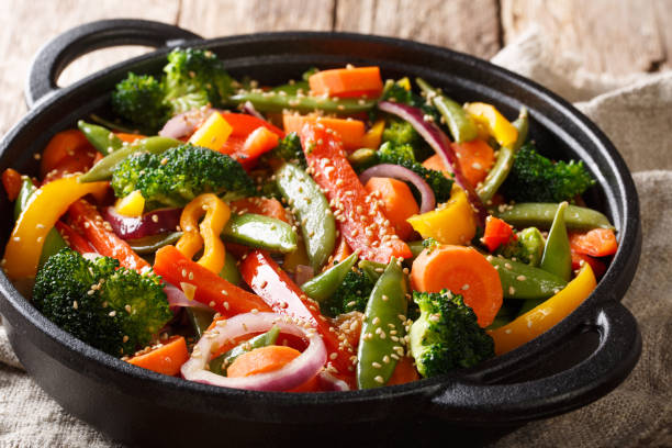 istock Fried vegetable mix with sesame close-up in a bowl, horizontal 1156405891