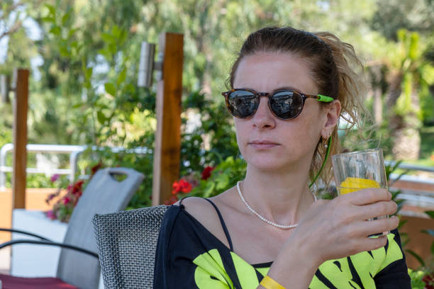 Woman having vacation in resort and enjoying her drink.