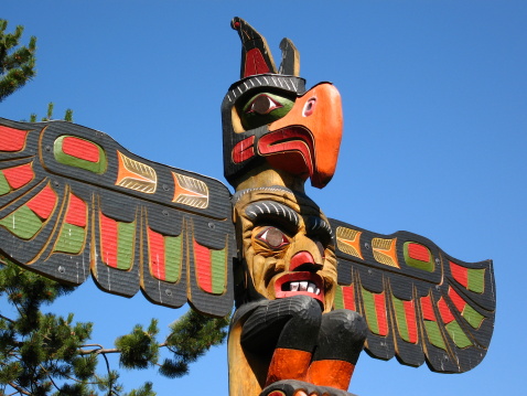 The top of a beautifully painted totem pole in Victoria, British Columbia.