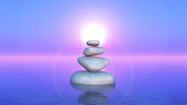 istock 3D balancing rocks in the ocean against a sunset sky 1156413937