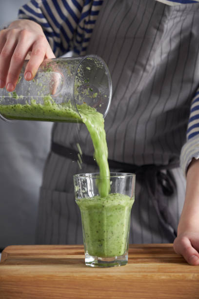 istock Pouring fresh smoothie into a glass 1156414669