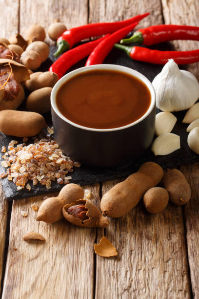 istock Asian freshly prepared tamarind sauce with ingredients close-up on a table. vertical 1156415392