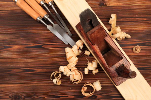 istock chisels plane and sawdust on a wooden table - Image 1156415428