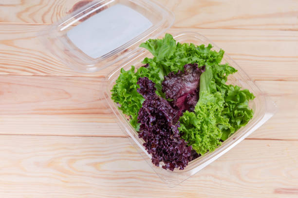 istock Top view of red and green lettuce leaves in container 1156418341