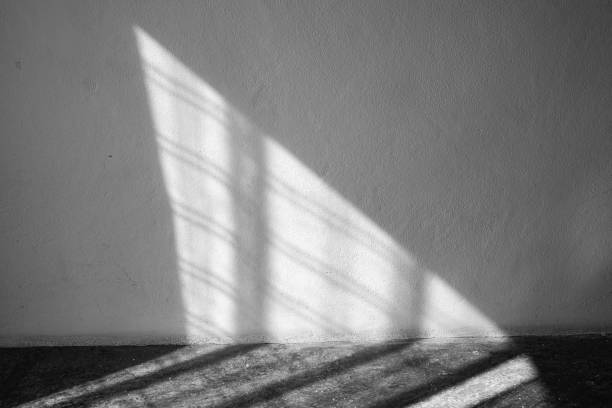 istock Light through curtain to white coloured Cement wall and Grey coloured concrete floor, Textures Reflection Light concept, Black & White photo 1156420407