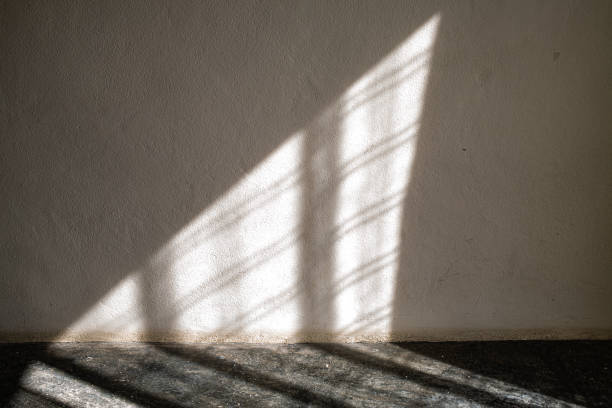 istock Light through curtain to white coloured Cement wall and Grey coloured concrete floor, Textures Reflection Light concept 1156420494