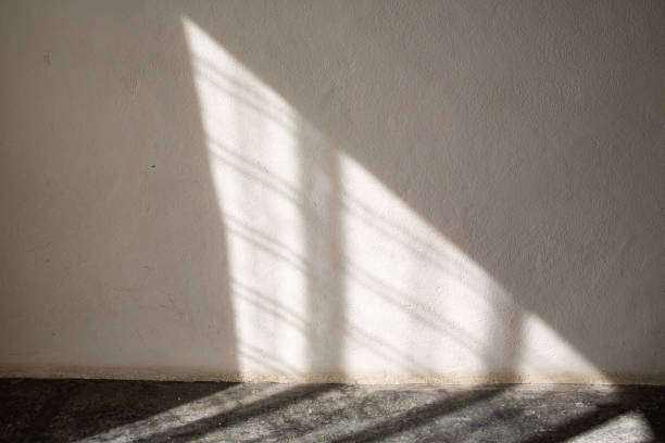 istock Light through curtain to white coloured Cement wall and Grey coloured concrete floor, Textures Reflection Light concept 1156420501