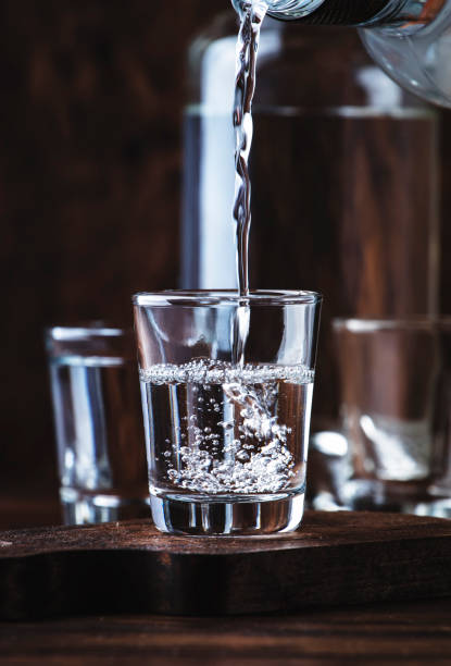 aguardiente - traditional spanish strong alcoholic drink, grape moonshine or vodka, in glasses on an old wooden table, place for text - russian shot imagens e fotografias de stock