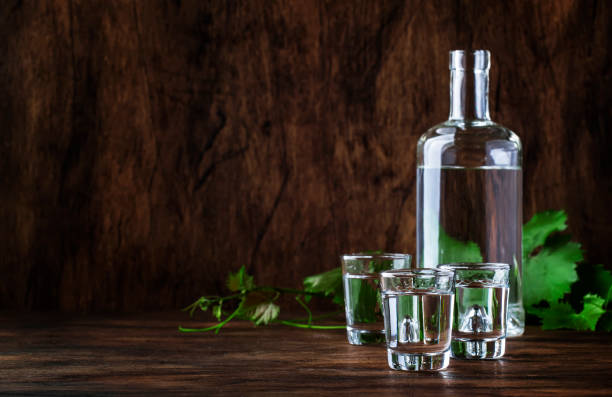 Aguardiente - traditional Spanish strong alcoholic drink, grape moonshine or vodka, in glasses on an old wooden table, place for text Aguardiente - traditional Spanish strong alcoholic drink, grape moonshine or vodka, in glasses on an old wooden table, place for text rum photos stock pictures, royalty-free photos & images